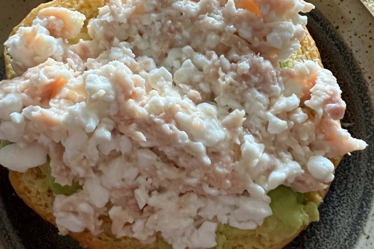 Cottage cheese and tuna mixed together on a sandwich bun. 