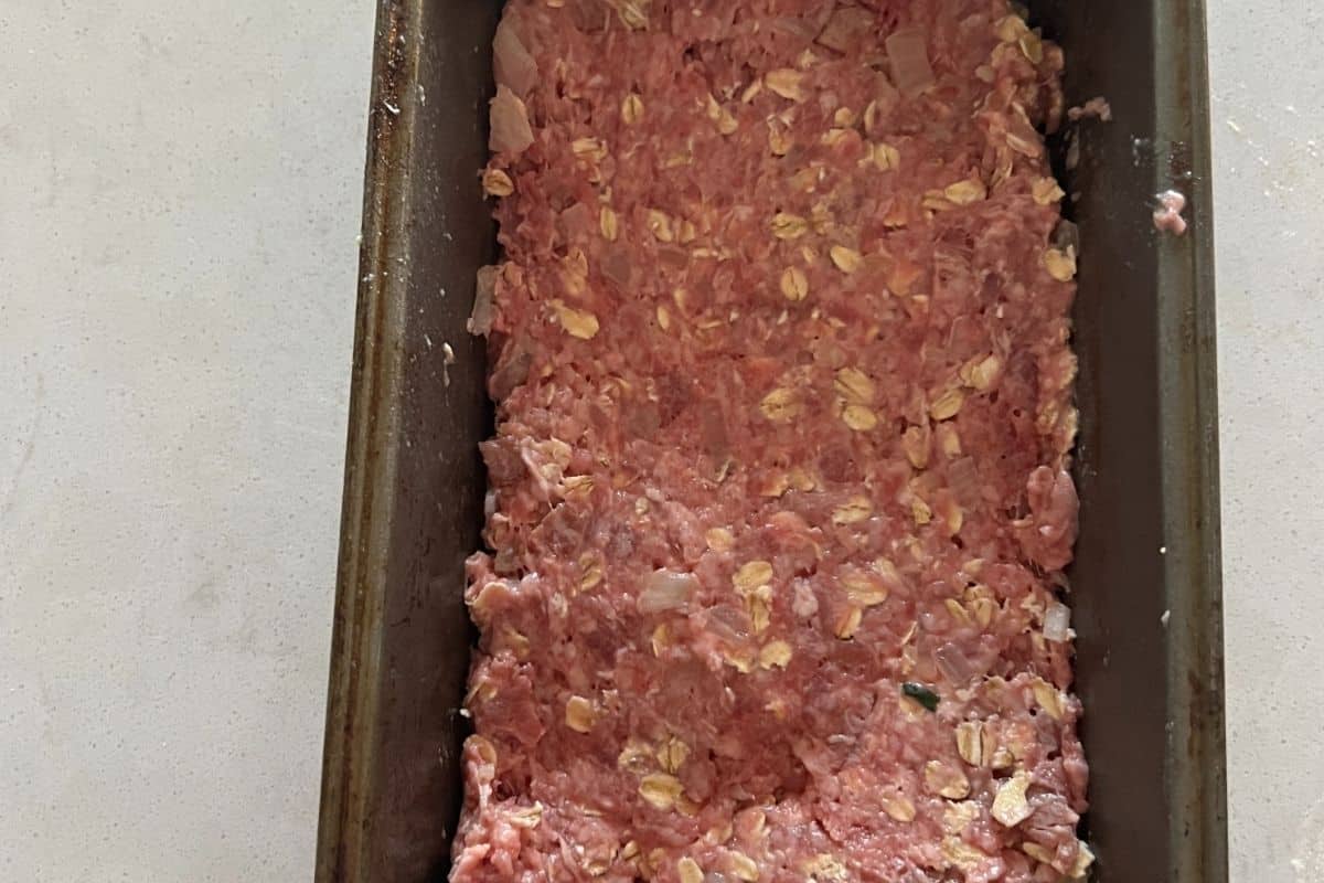 Turkey meatloaf mixture combined together in a bread loaf pan. 