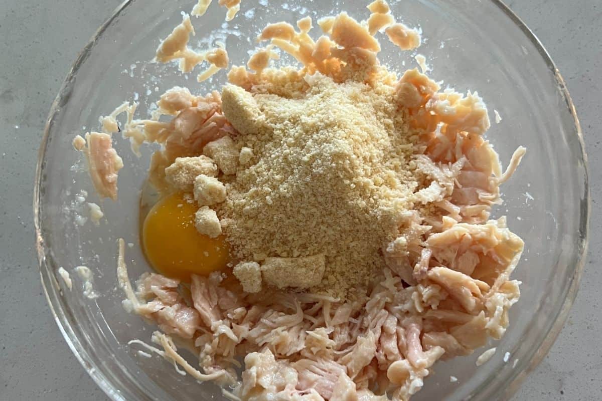 Pizza crust chicken ingredients mixed together in a bowl. 