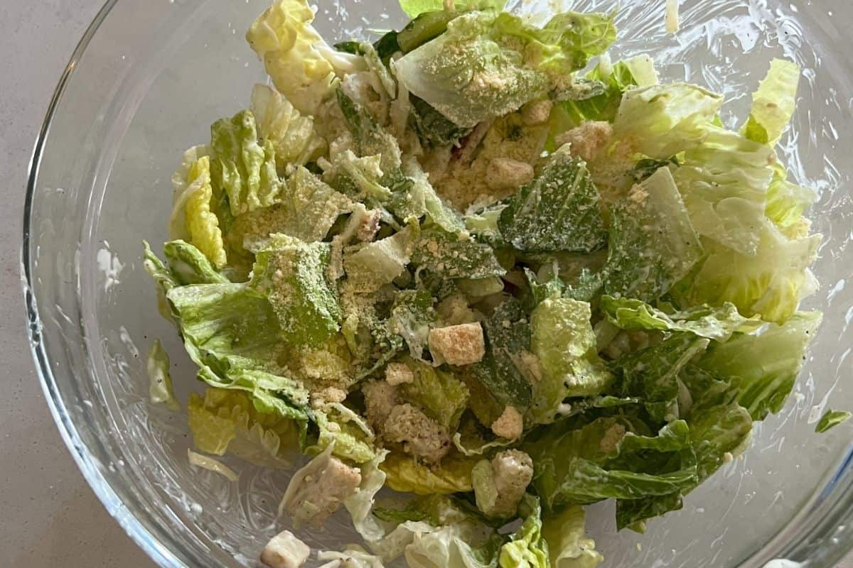 Ceasar Salad ingredients combined in a bowl. 