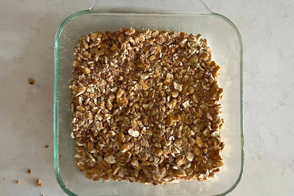 Crushed pretzels in a clear baking dish. 