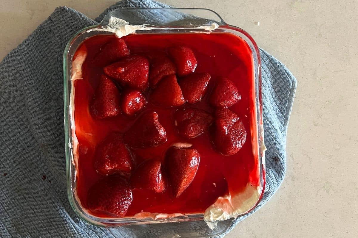 Strawberry and jello mixture poured on top of cream cheese mixture.