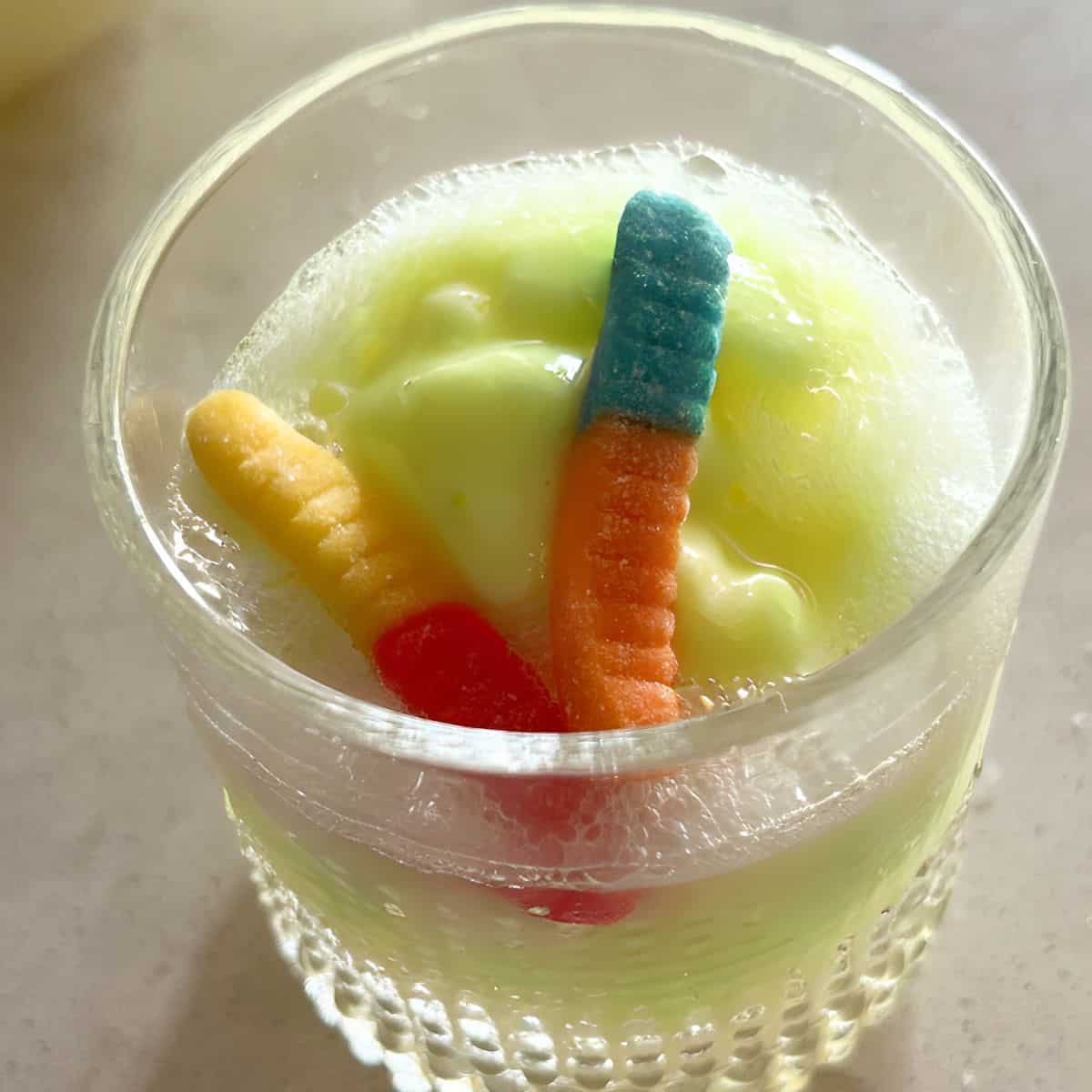 Swamp punch topped with gummy worms. 
