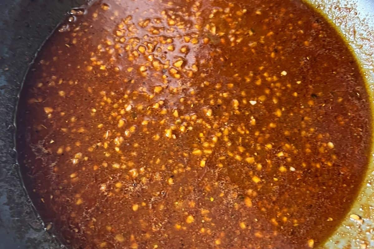 Sauce ingredients cooking in a pan for egg boil. 