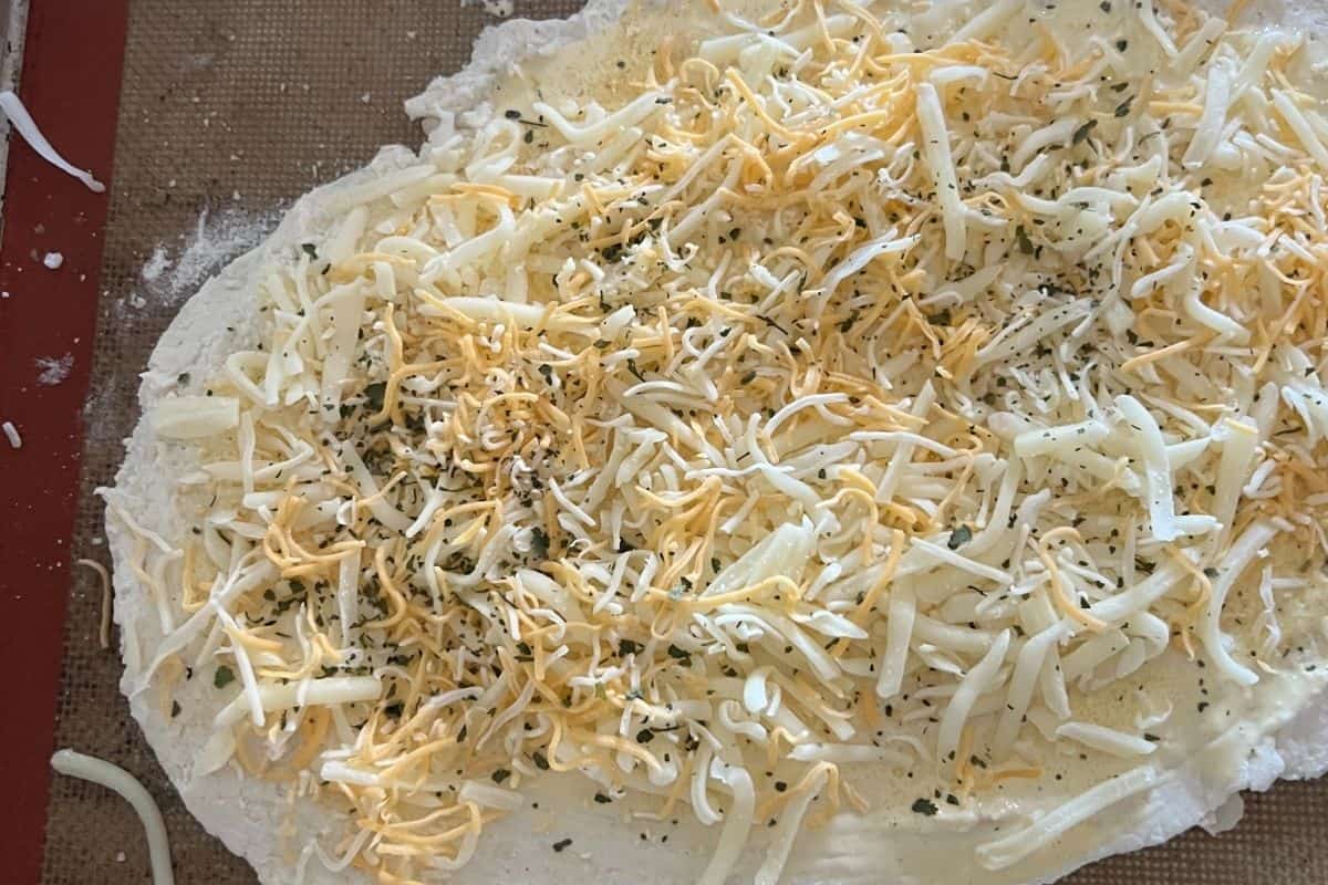 2 ingredient dough topped with butter, garlic, and cheeses. 