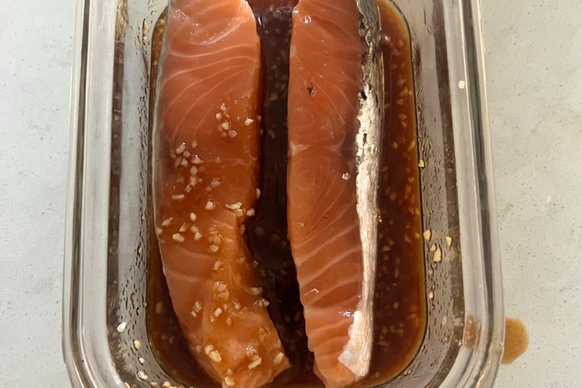 Salmon marinading in glass pyrex bowl. 