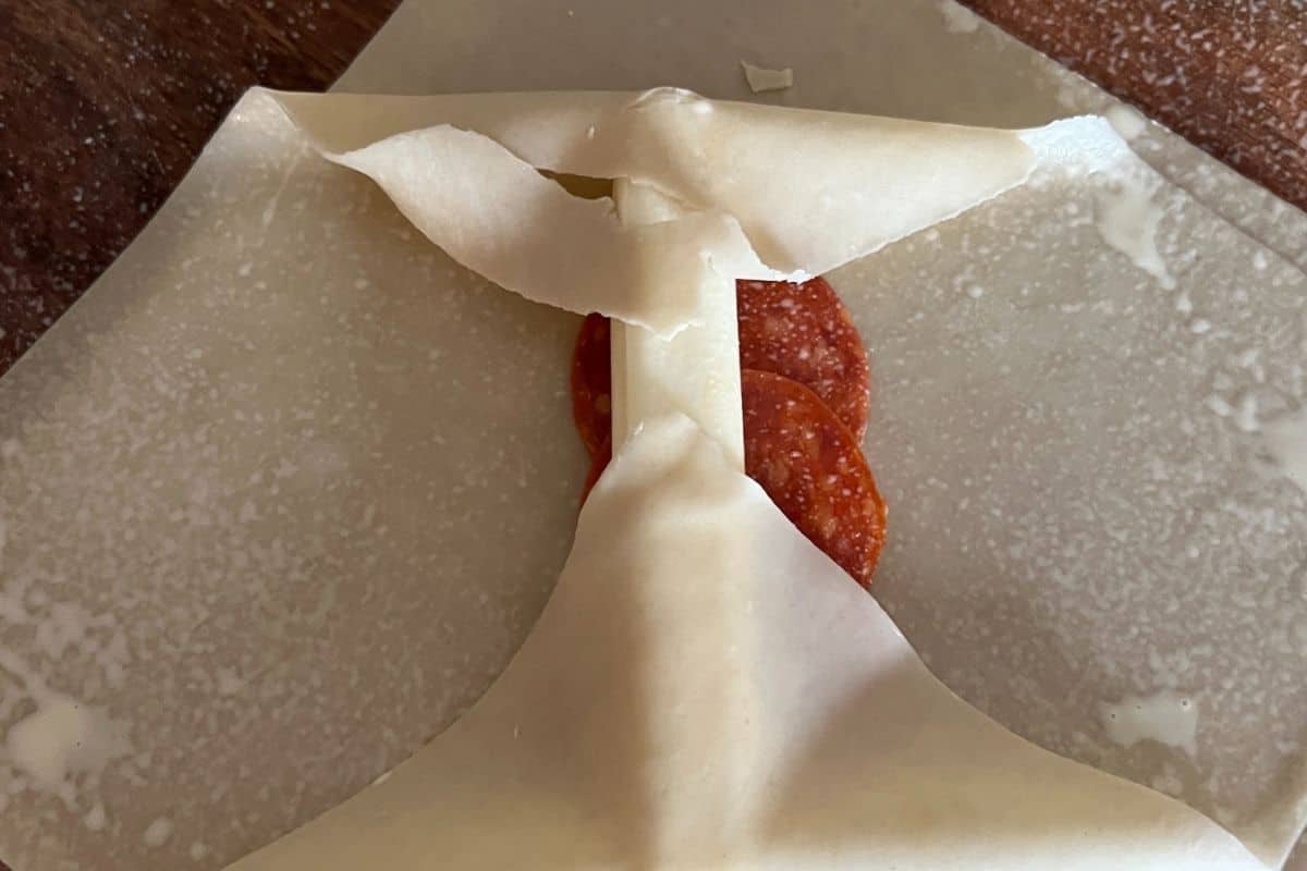 Egg roll wrappers sprayed with butter on sides. 