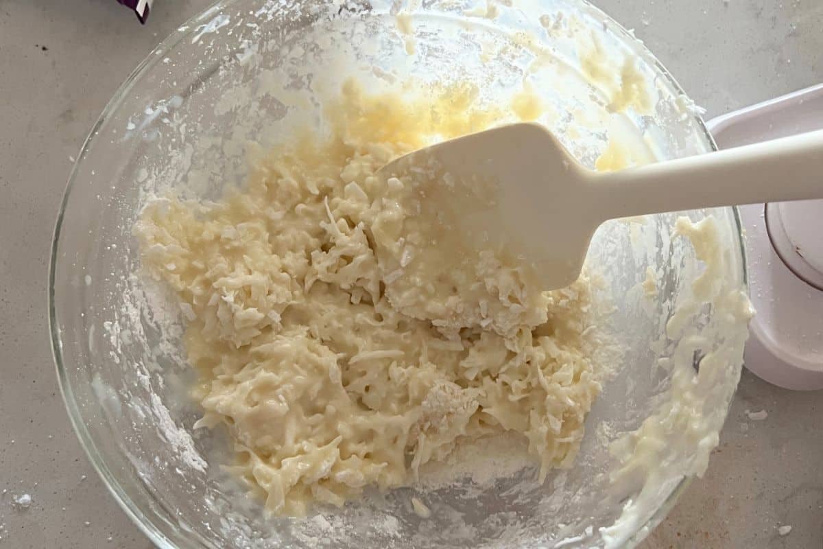 Coconut and sugar combined in a bowl. 