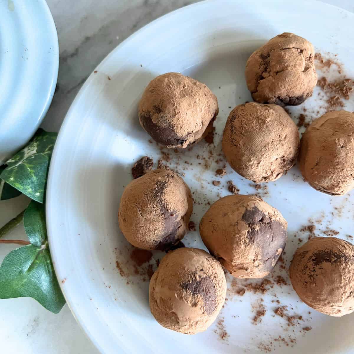 Decadent chocolate truffles with rum-soaked raisins. Such an easy and fancy treat or dessert to have. 