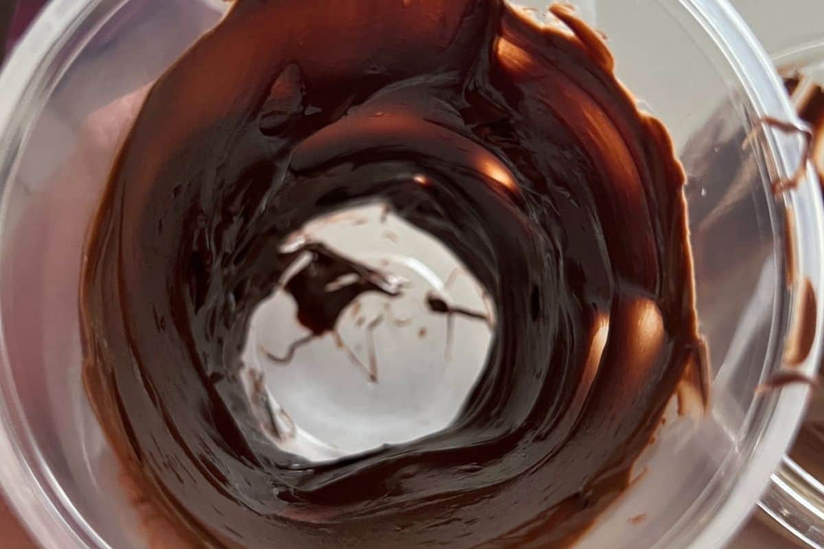 Plastic cup filled with melted chocolate.