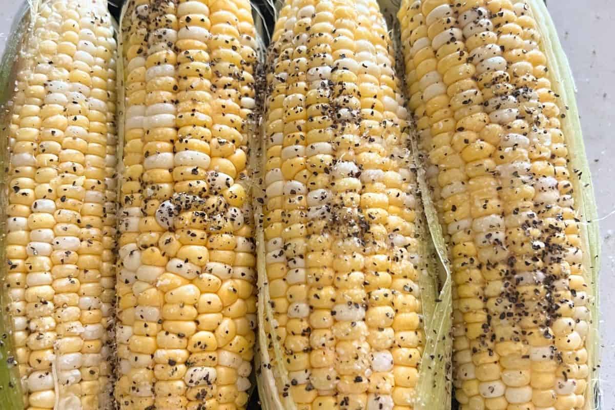 Seasoned corn on the cob with salt and pepper.