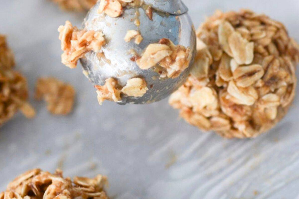 Scooped out banana oat energy bites on a baking sheet.