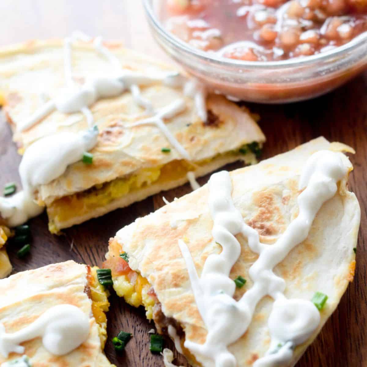 Breakfast quesadilla with sour cream and salsa.