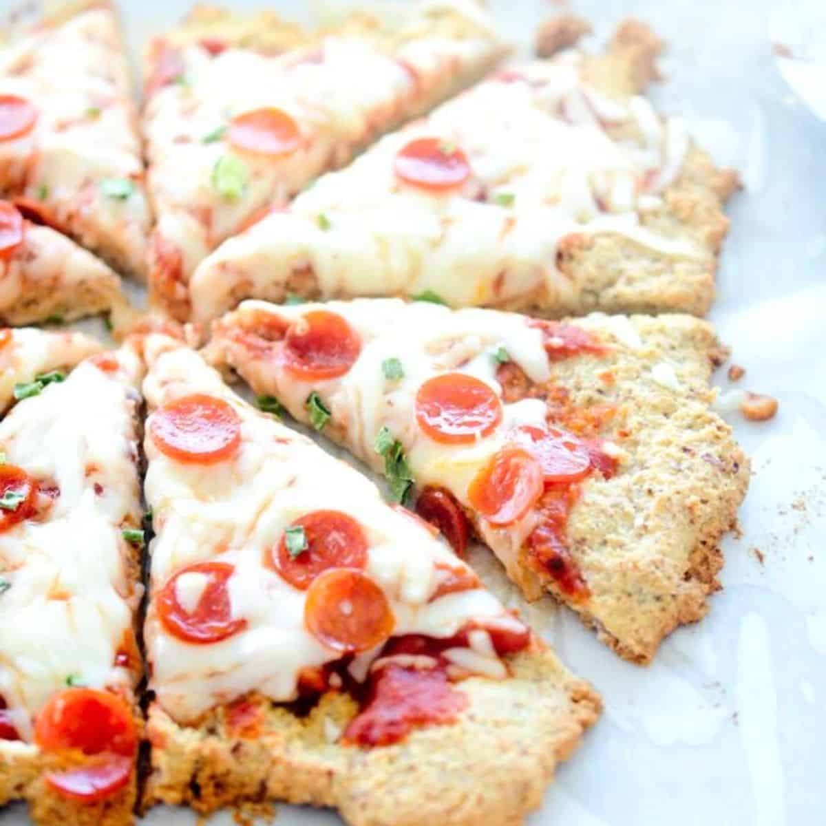 Low carb almond flour pizza crust topped with cheese, sauce, and pepperoni.