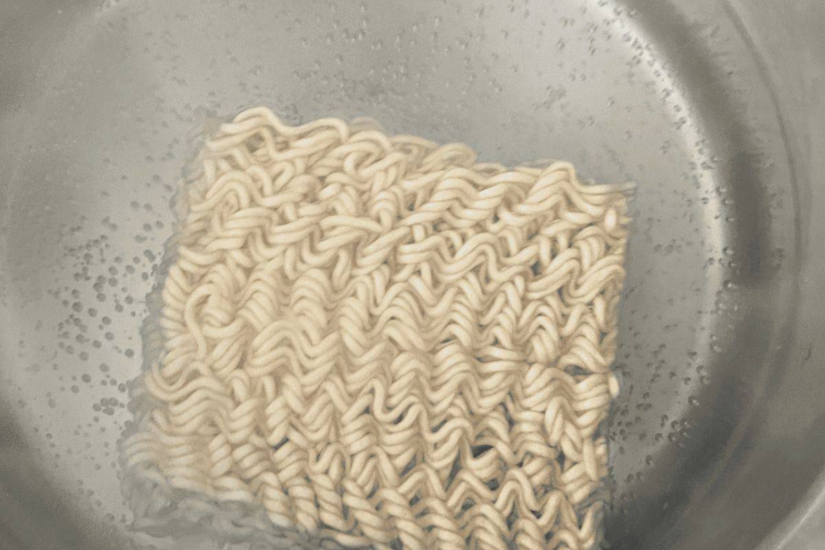 Ramen noodles boiling in water.