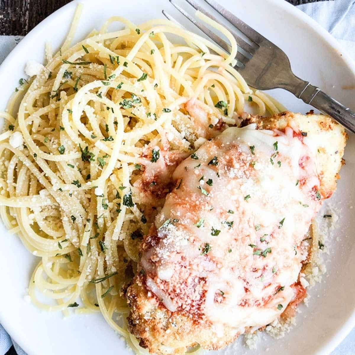 Air fried parmesan chicken with a side of noodles.