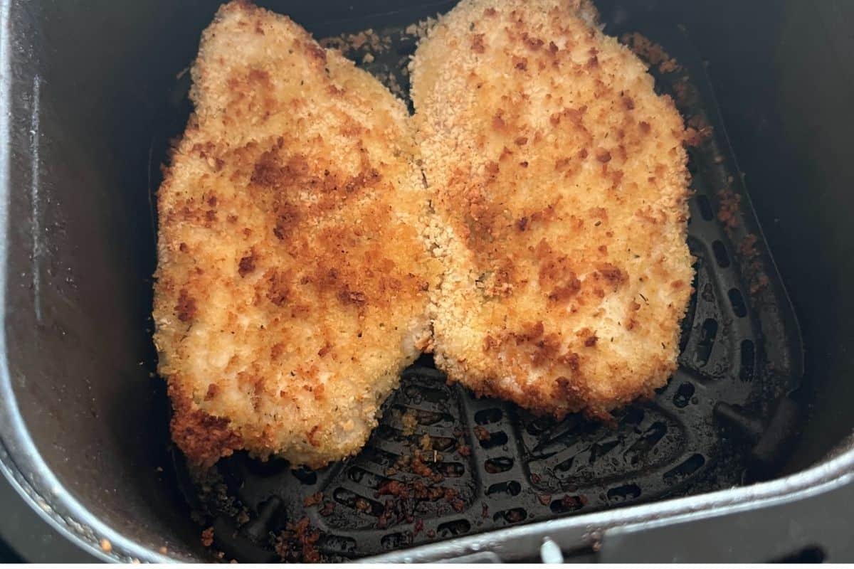 Air fryer chik fil a sandwiches in air fryer basket.
