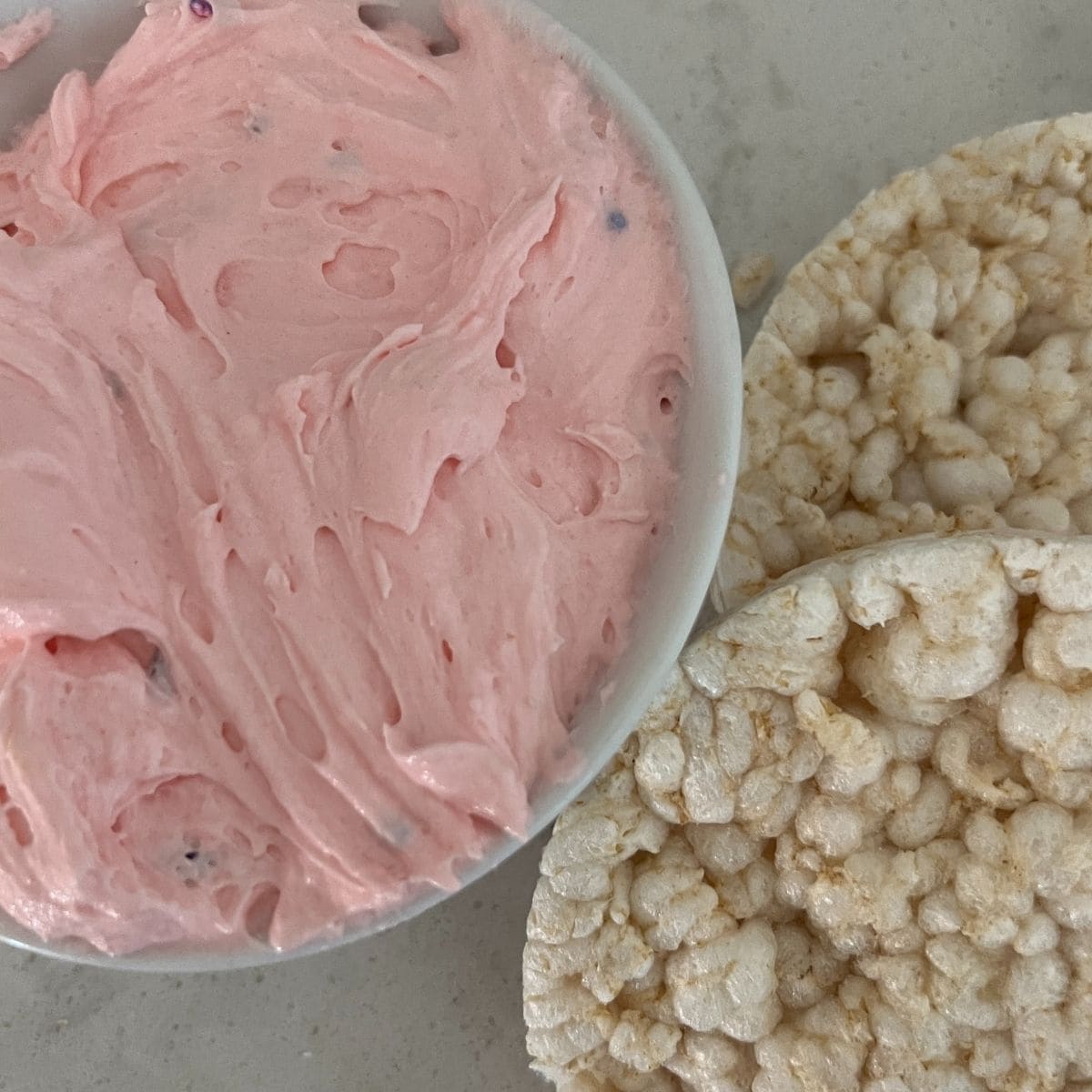 Dunkaroo Dip in a white bowl next to rice crackers.