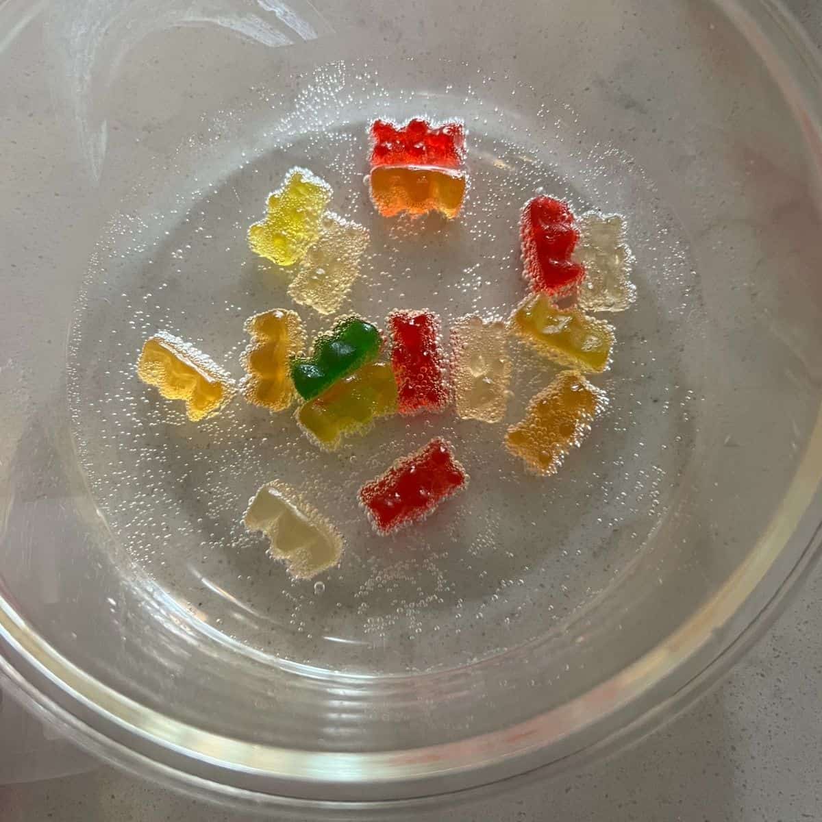 Gummy bears in a bowl of sprite. 
