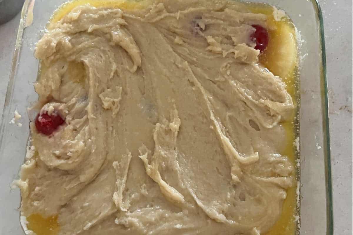 Cake mix poured over cherries and pineapples.