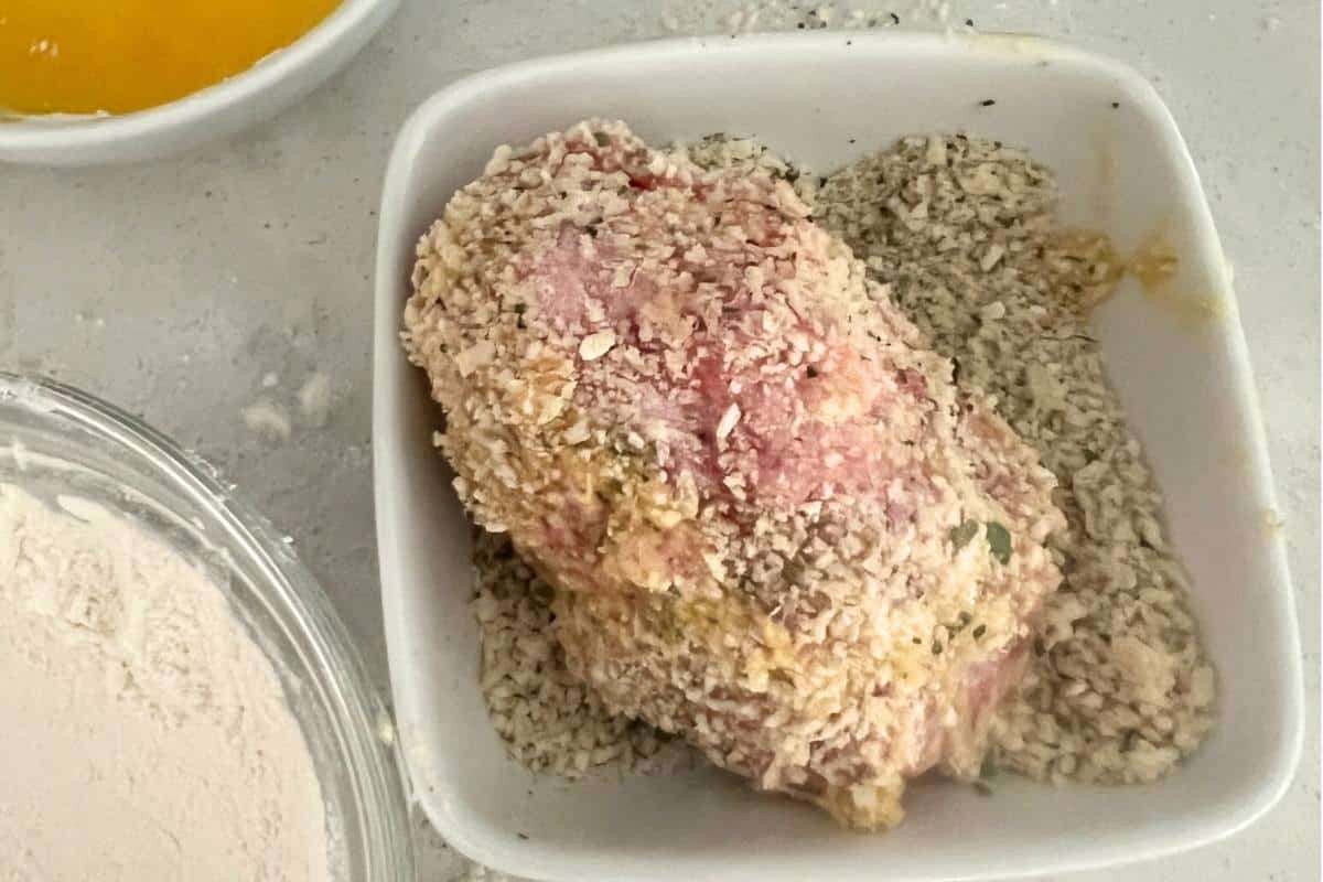 Coated scotch eggs covered in sausage and dipped in bread crumbs.