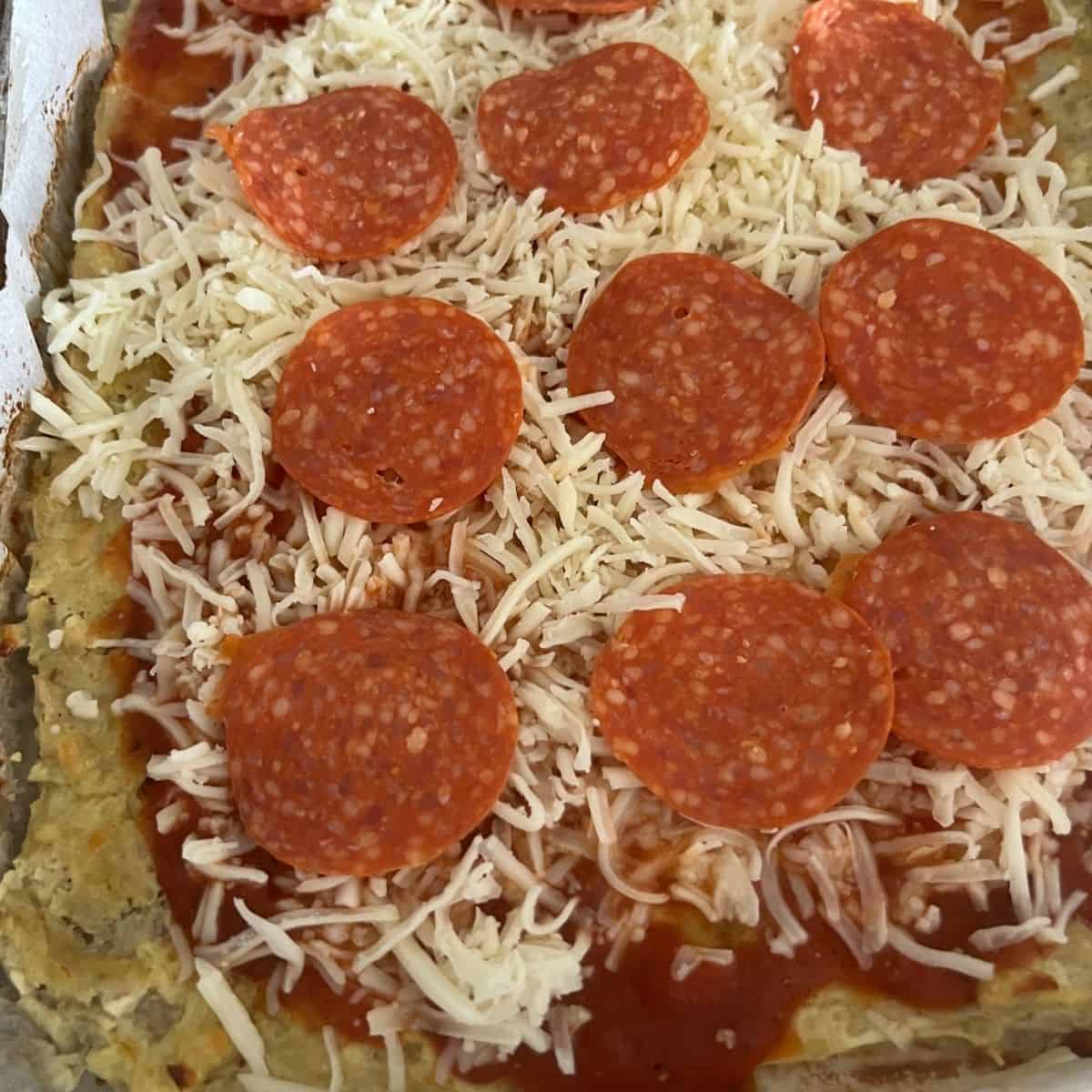 Carnivore pizza crust with toppings.