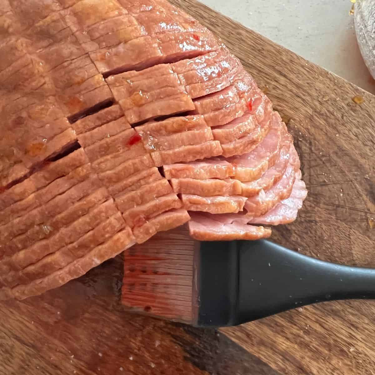 Brushed glaze on top of ham.