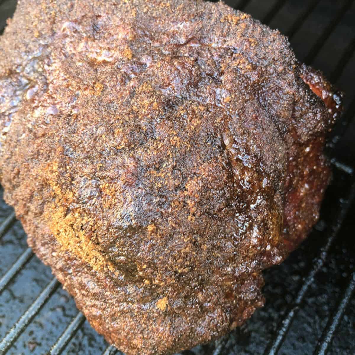 Smoked pulled pork gets brined in apple juice all day or overnight, rubbed with seasoning, and then cooks all day long on a smoker for up to 8 hours.