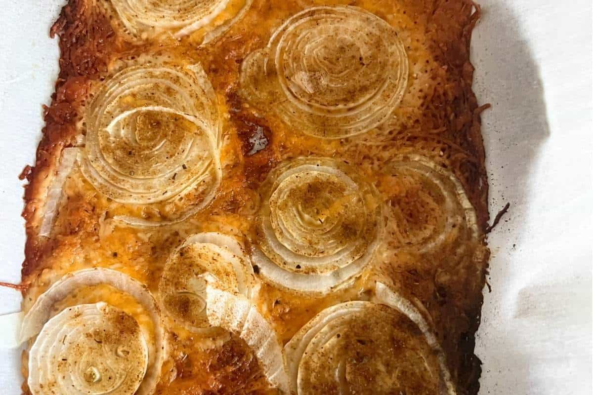 Onions and cheddar arranged on a baking sheet. Finished viral onion chips.