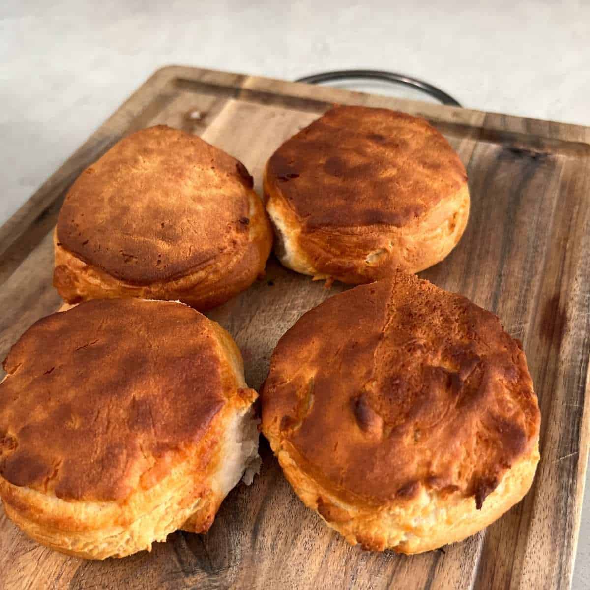 Air fried canned biscuits on cutting board.