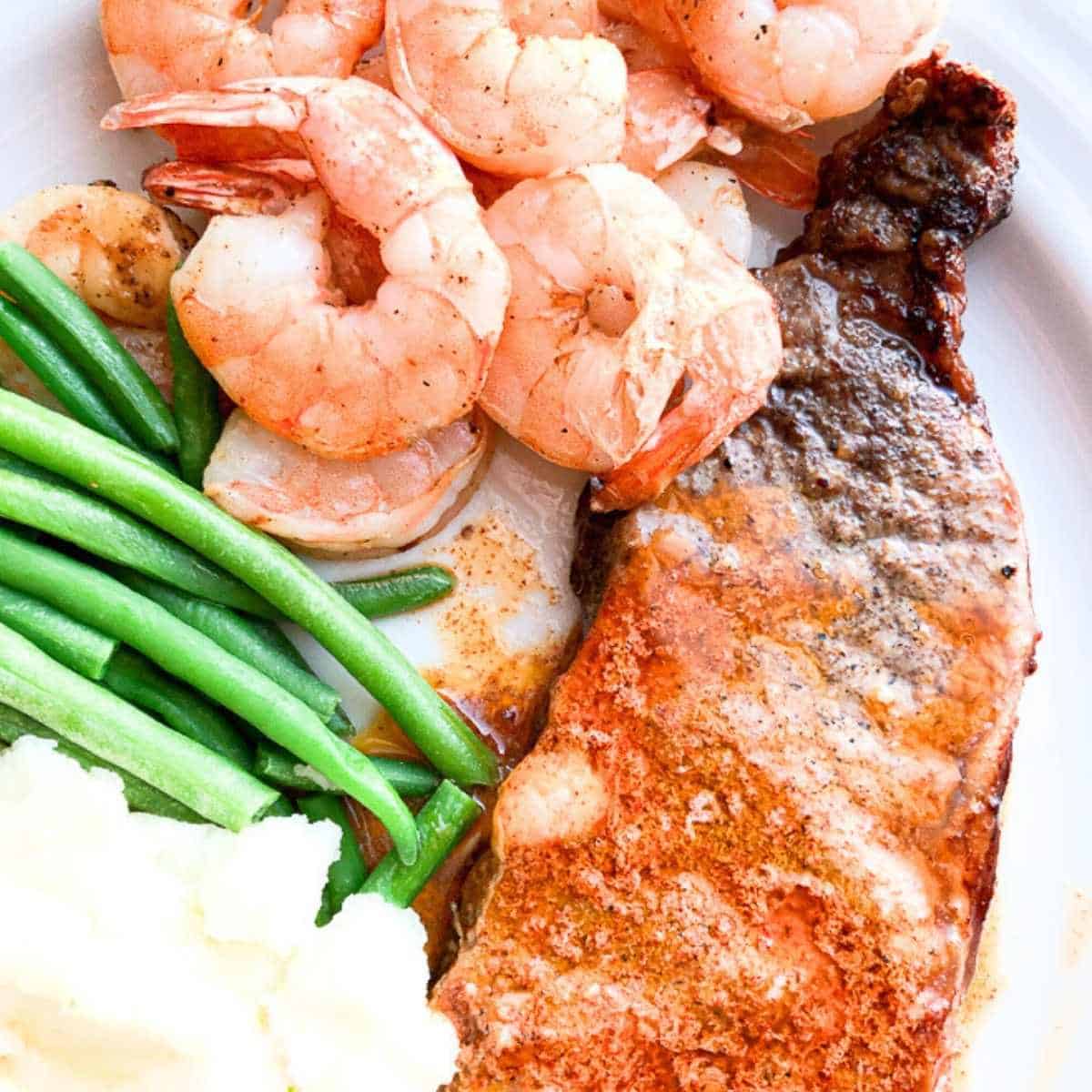 Air fried shrimp and steak with green beans and mashed potatoes.