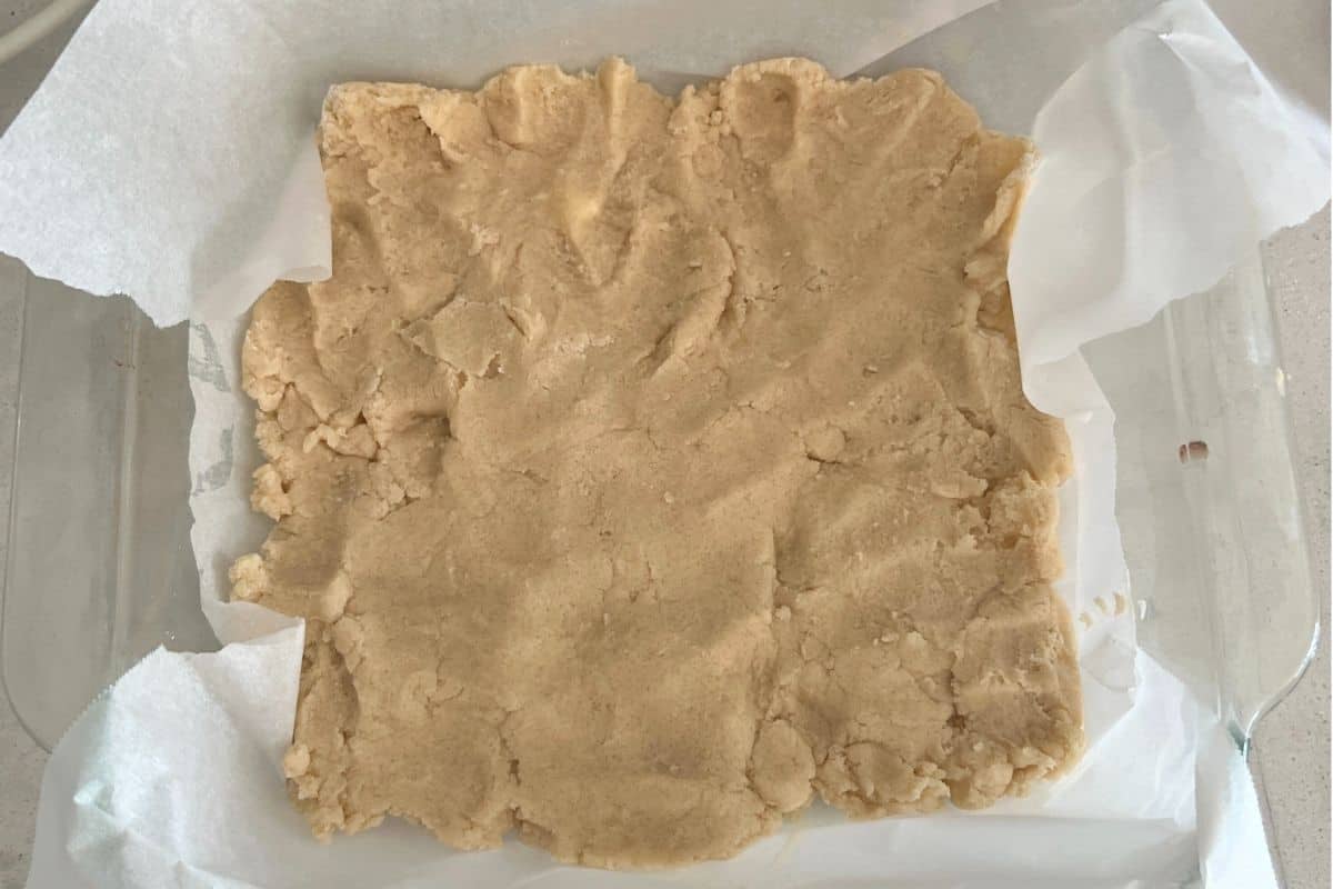 Salted Carmel bars dough pressed in a pan.