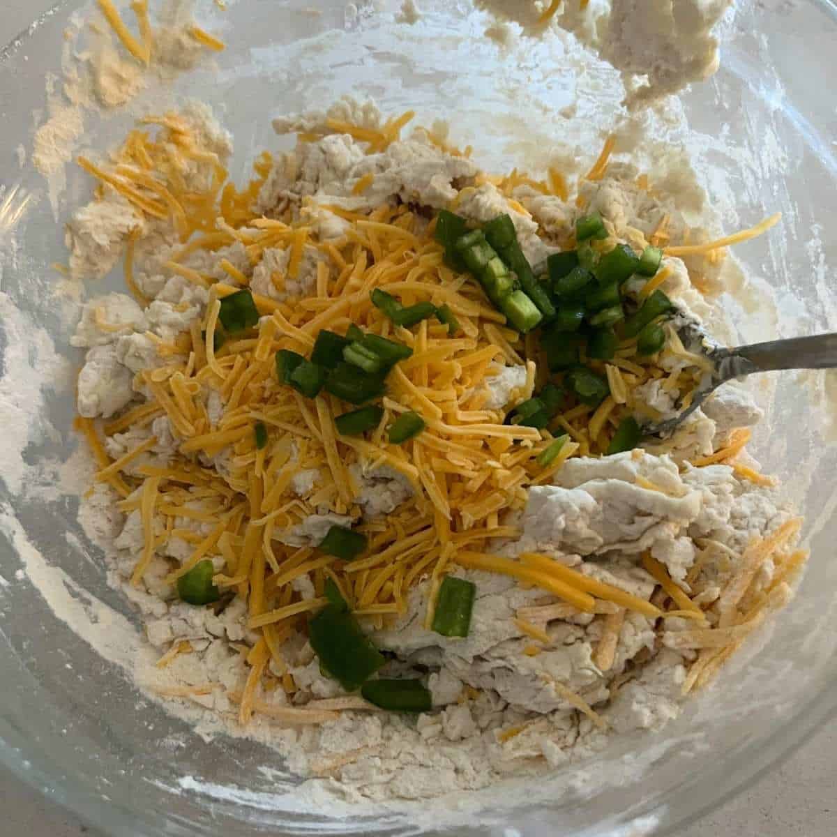 Cheddar bagel dough mixed in a bowl.