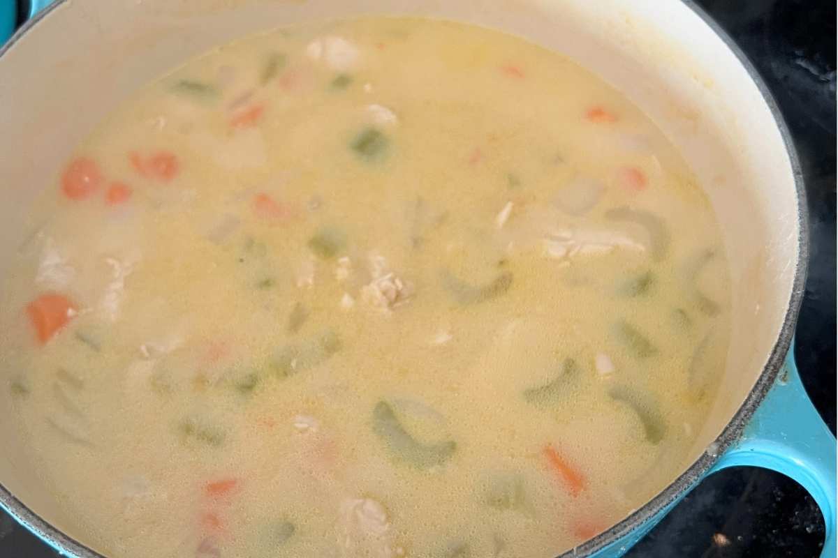 Chicken broth and milk mixed in a pot.