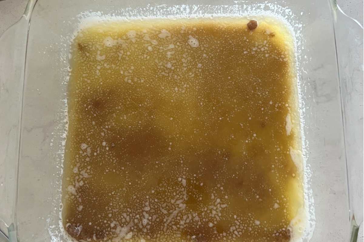 Butter and brown sugar melted in a glass baking dish.