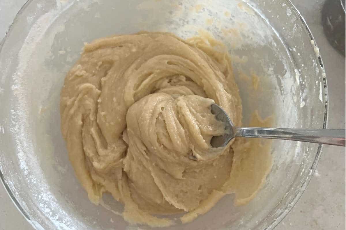 Cake mix batter ingredients stirred into a bowl.