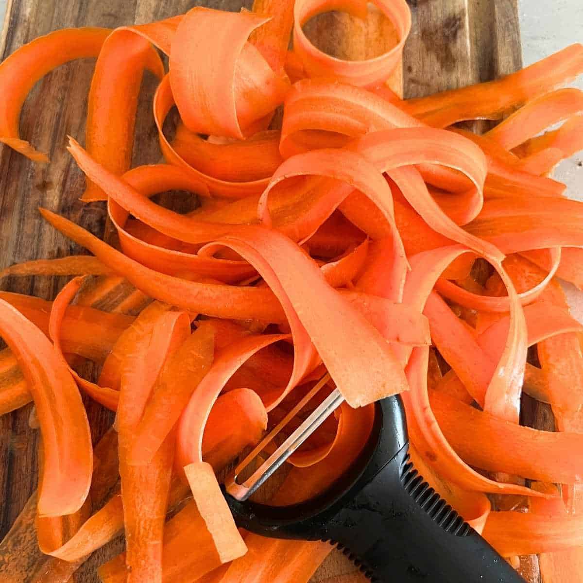 Raw carrots peeled into carrot ribbons.