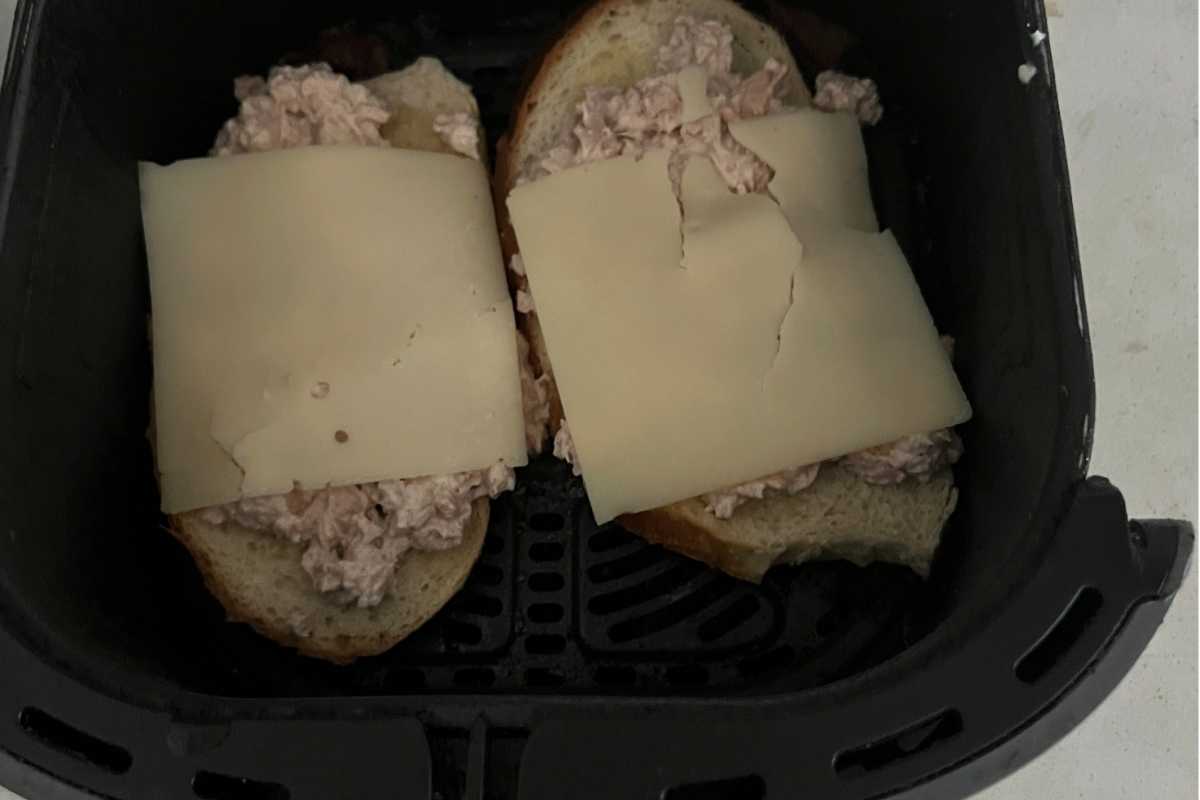 Layered tuna and cheese on top of bread. 