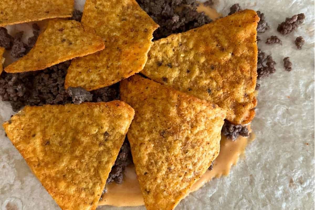 Crunchwrap layered with toppings ready for Blackstone.