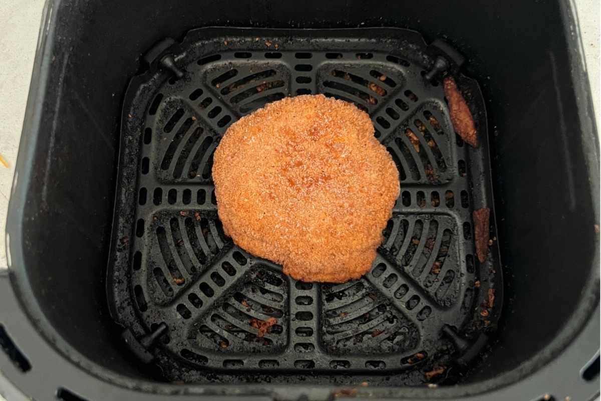 Breaded chicken patty in air fryer.
