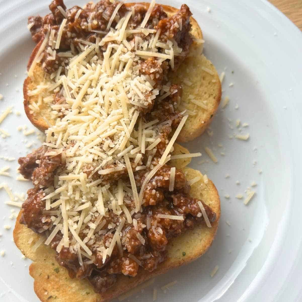 Toasted air fryer garlic bread topped with spaghetti sauce. 