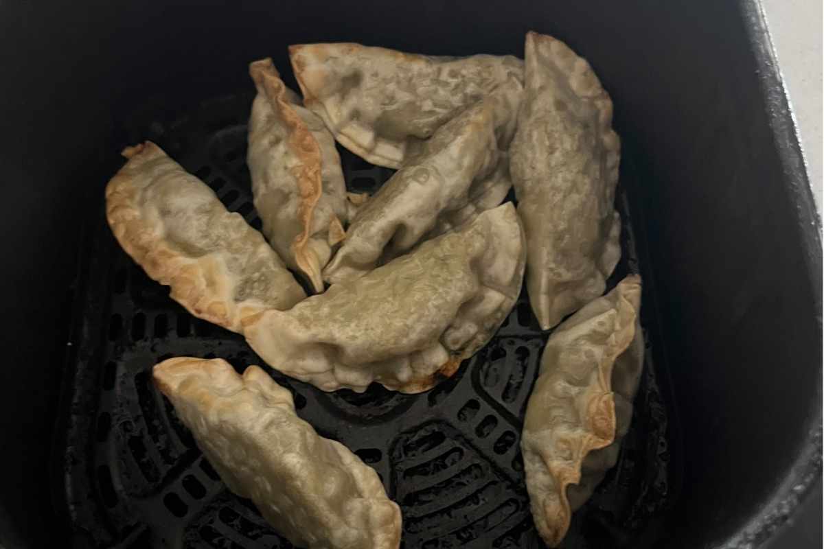 Cooked air fried potstickers in air fryer.