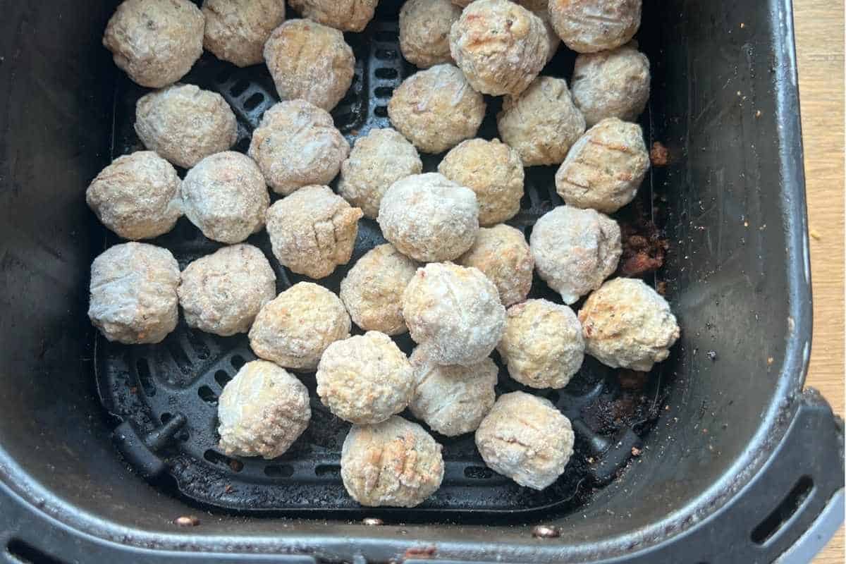 Frozen Meatballs in Air Fryer Basket.