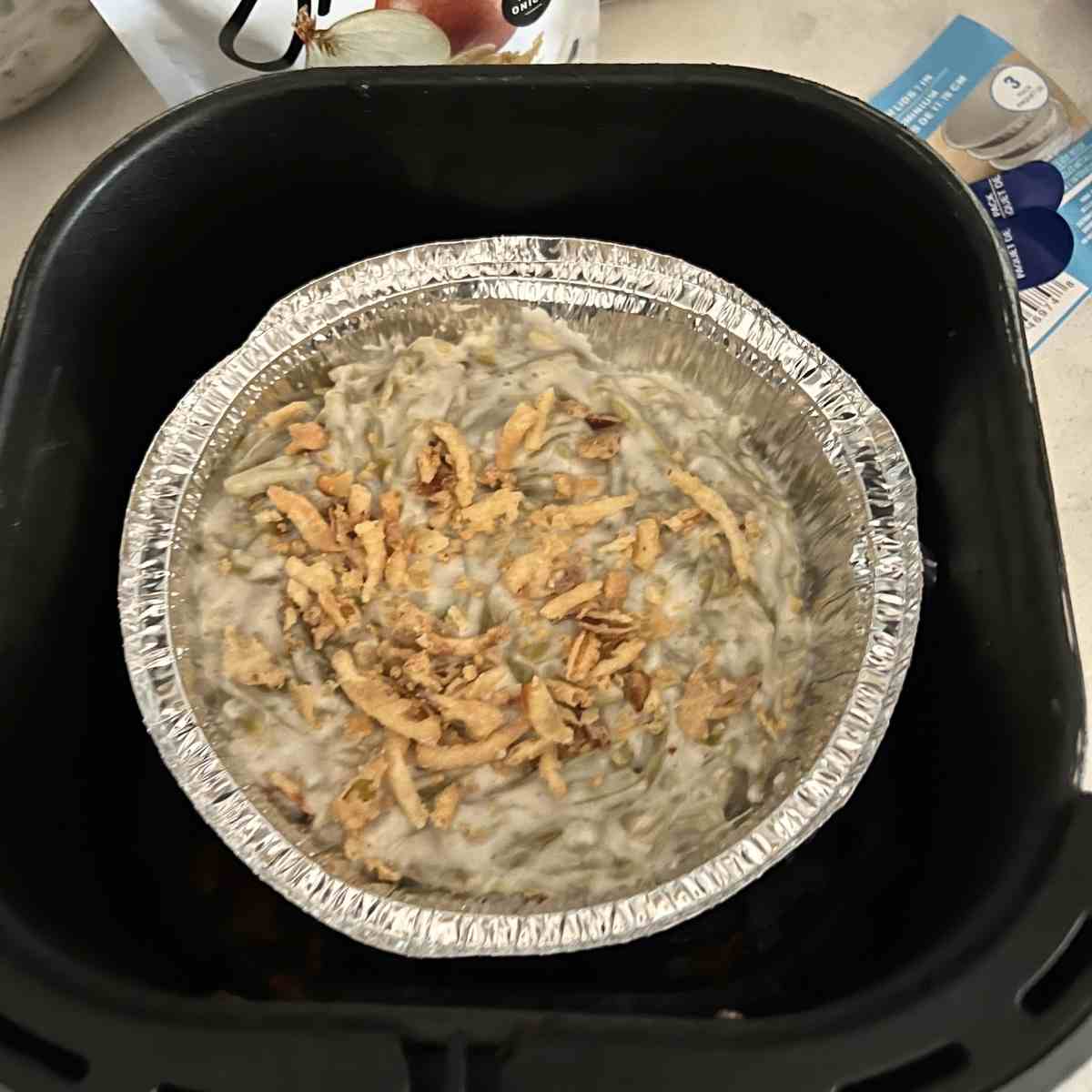 Green bean casserole mixed in a bowl ready for air fryer. 