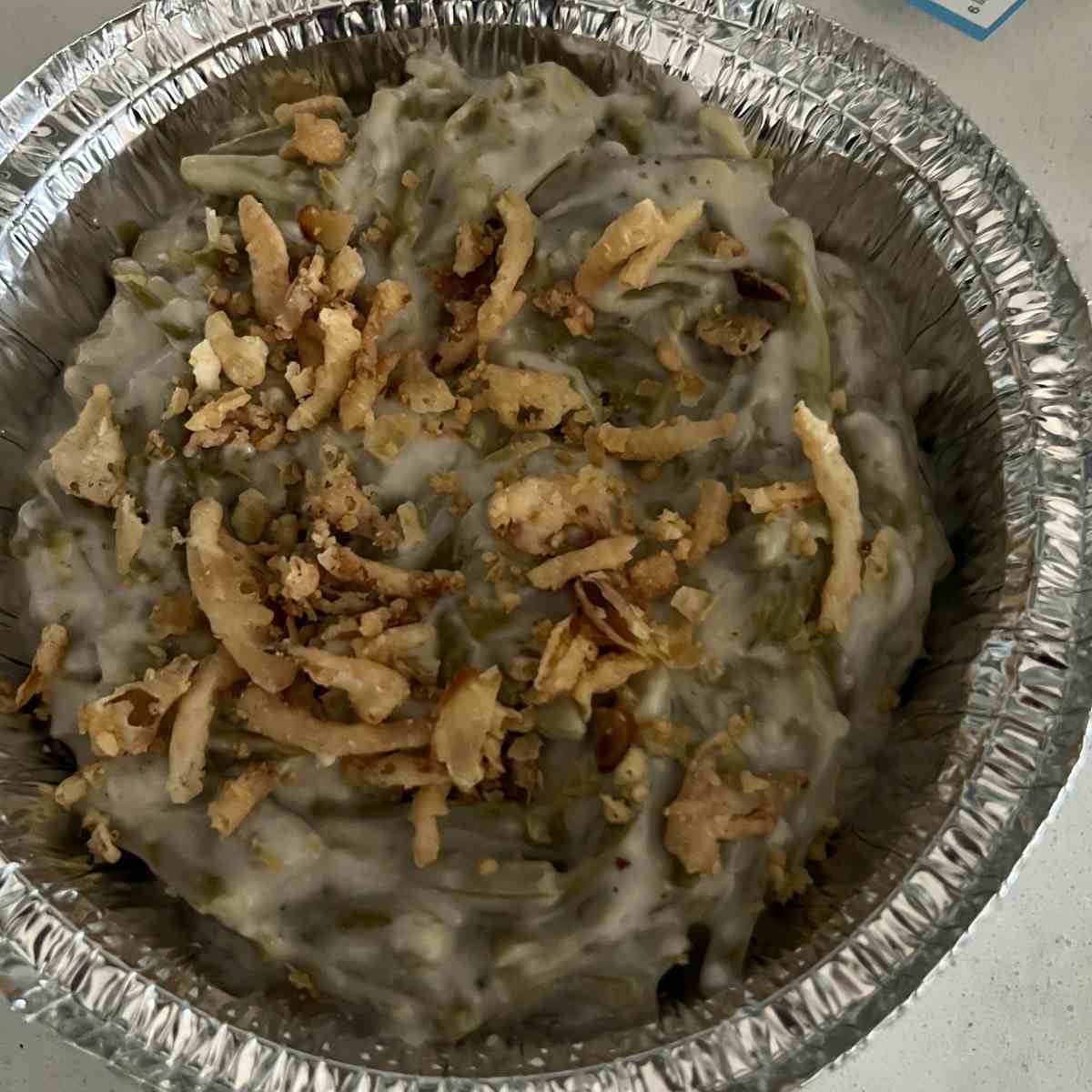 Green bean casserole mixed in a bowl in a tinfoil. 