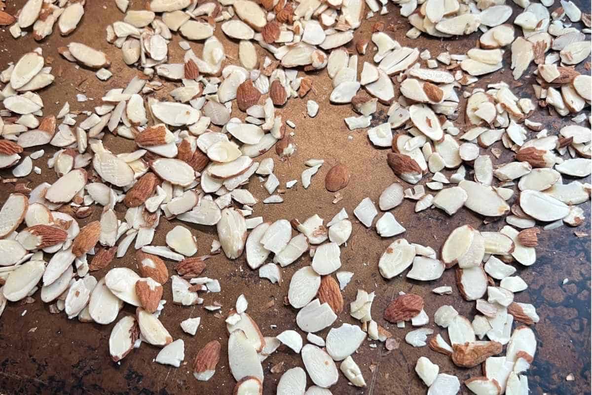 Toasted slivered almonds on a sheet pan.