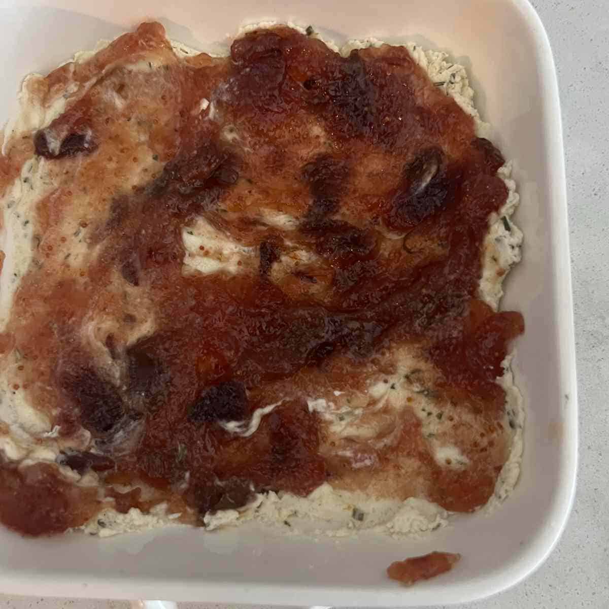 Fig jam spread on top of Boursin cheese.