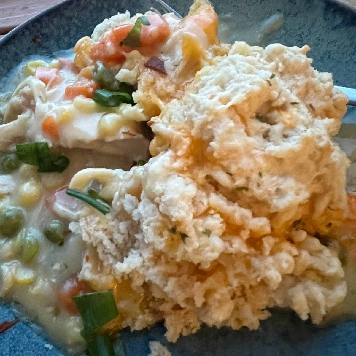 Chicken pot pie with Garlic Cheddar Bay Biscuits on a plate.