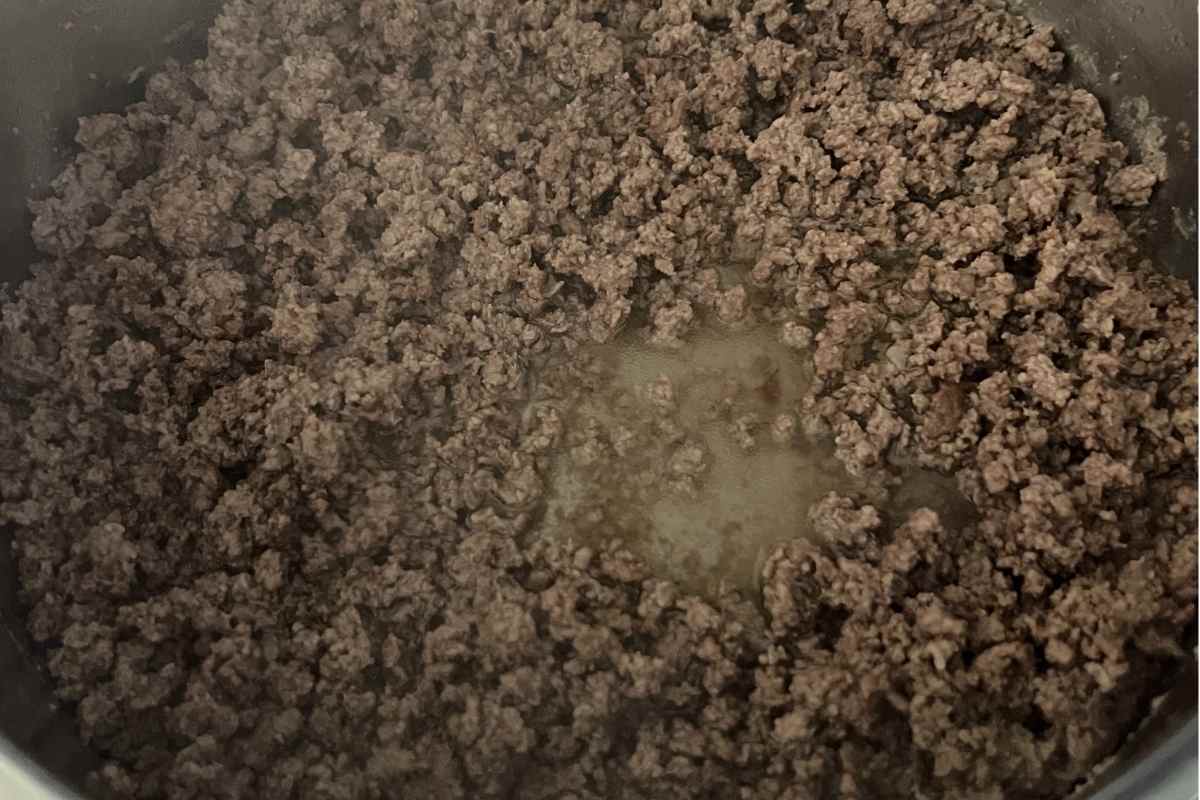 Ground beef cooking in a skillet.