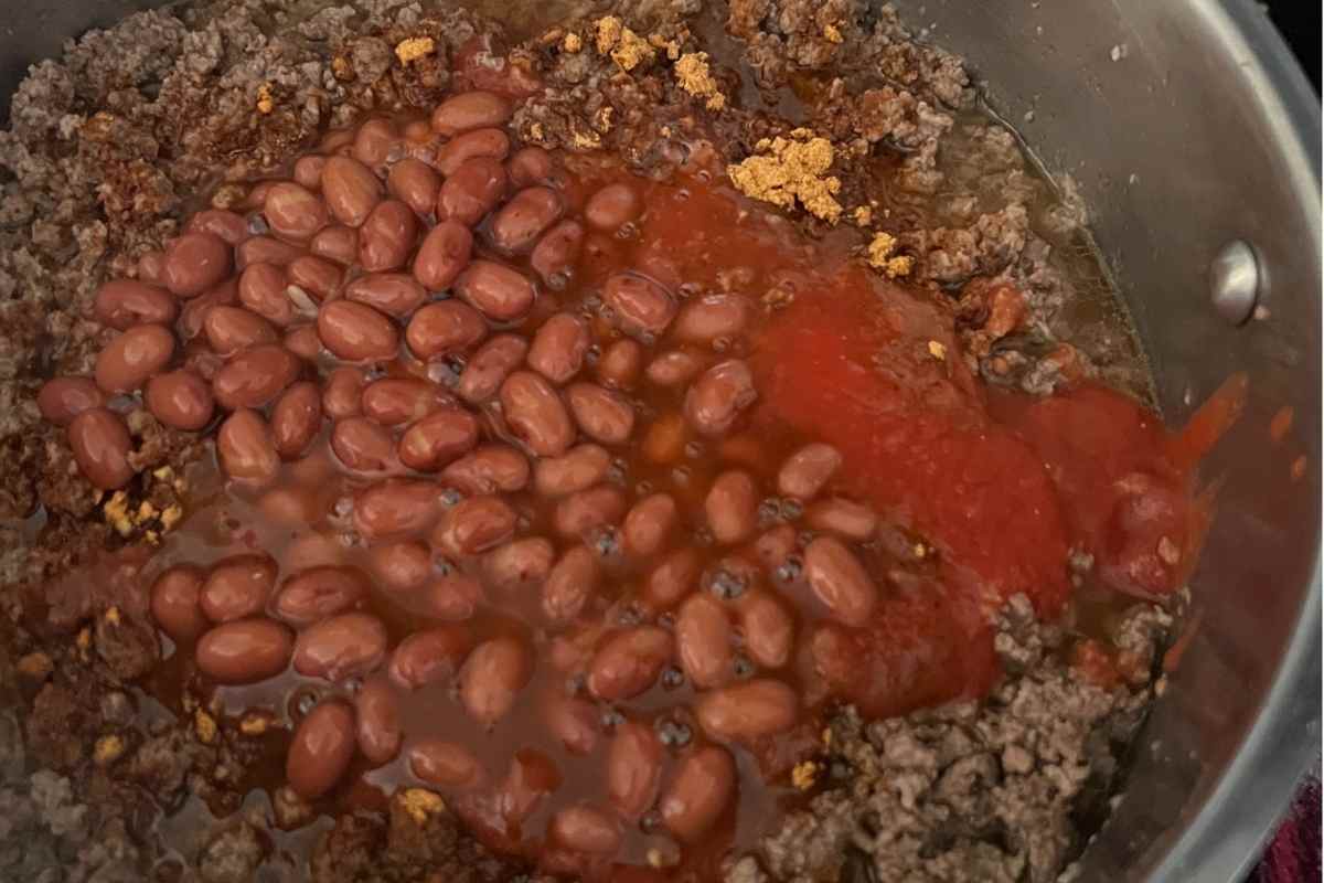 Ingredients for chili recipe cooking in a pan.